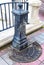 Old and worn water fountain with a broken drainage grate by the esplanade in Sliema, Malta