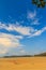 Old wreck fishing boat buried in the sand with blue sky on cloud