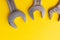 Old wrenches on a yellow background. From above. Place for text