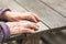 Old wrinkled female hands on a wooden table