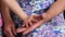 Old wrinkled hands touch and clap kid soft hands. Closeup hands of grandchild and grandmother