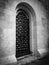 Old wrought iron door in the Church of Alexander Nevsky, black and white image.