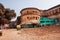 Old yellow auto rickshaw drive past the walls of Ramnagar Fort in Varanasi