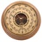 Old yellow-brown aneroid barometer in wooden body on a white