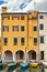 Old yellow building and boats in the canal in Chioggia