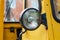 Old yellow forklift truck front headlight closeup