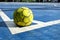 Old Yellow futsal Ball on Blue Ground.