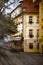 Old yellow house with flowers on windows and restaurant in Praha I, Mala Strana - old district of Prague near Charles bridge.