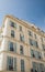 Old Yellow Plaster French Hotel with Green Shutters