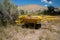 Old yellow rustic rusted wheelbarrow, abandoned. Taken at Bannack Ghost Town in Montana