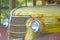 Old yellow rusty Chevrolet pickup truck grille and headlight