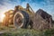 Old yellow wheel loader left in the field, view from the ground.