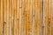 Old yellow wooden reed wall fence background