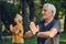 Older active couple do meditation practice outdoors