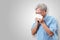 Older asian man is having flu and sneezing from sickness seasonal virus problem