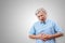 Older asian man is having stomach ache pain concept with isolated background. Senior or mature people suffering from digestion
