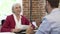 Older Businesswoman Interviewing Younger Man In Office