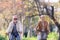 Older Caucasian couple riding bicycles through public park together