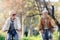 Older Caucasian couple riding bicycles through public park together