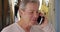 Older Caucasian man traveling in Italy makes phone call in the street