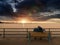 Older couple on bench enjoying Sunset