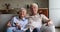 Older couple switch channels enjoy movie at home