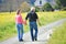 Older couple walking their dog on a country road