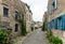 Older couple walks through the narrow streets of an idyllic French village