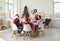 Older family member makes toast during traditional festive family Christmas dinner.