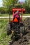 Older Farmer Plowing His Garden