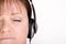 Older female listening to music on headphones