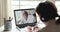 Older female online teacher giving distance lesson on laptop screen