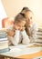 Older girl hugging very upset classmate at classroom