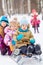 Older girl pushes sled with two little children