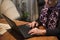 Older grandmother enjoys her laptop relaxed in the armchair of her home