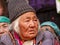 Older gray-haired ladakhi women in traditional clothes and jewelry among the crowd of observers watching Yuru Kabgyat festival