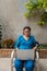 An older hispanic woman checking her blood pressure and pulse at home