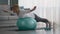 Older Lady Exercising On Swiss Ball Having Workout At Home