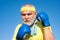 Older man boxing - close up portrait. Handsome elderly man practicing boxing kicks. Senior sport man wearing boxing