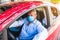Older man and his family wear a sterile medical mask in the car. The concept of preventing the spread of the epidemic and treating