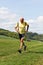 Older man jogging running on meadow