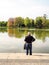 Older man overlooking the pond in the Maschpark in Hannover, Germany