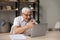 Older man read message use laptop celebrate great news