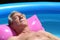 Older man sunbathing on a lilo