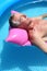 Older man sunbathing on a lilo