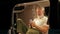 Older man traveler sitting in camper van using mobile in camping at night.