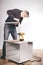 Older man working at home on kit of cabinet with laminated wooden drawers