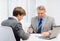 Older man and young man having meeting in office