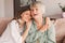 Older mature mother and grown millennial daughter laughing embracing, caring smiling young woman embracing happy senior middle