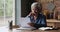 Older mature woman reading paper letter, feeling stressed.